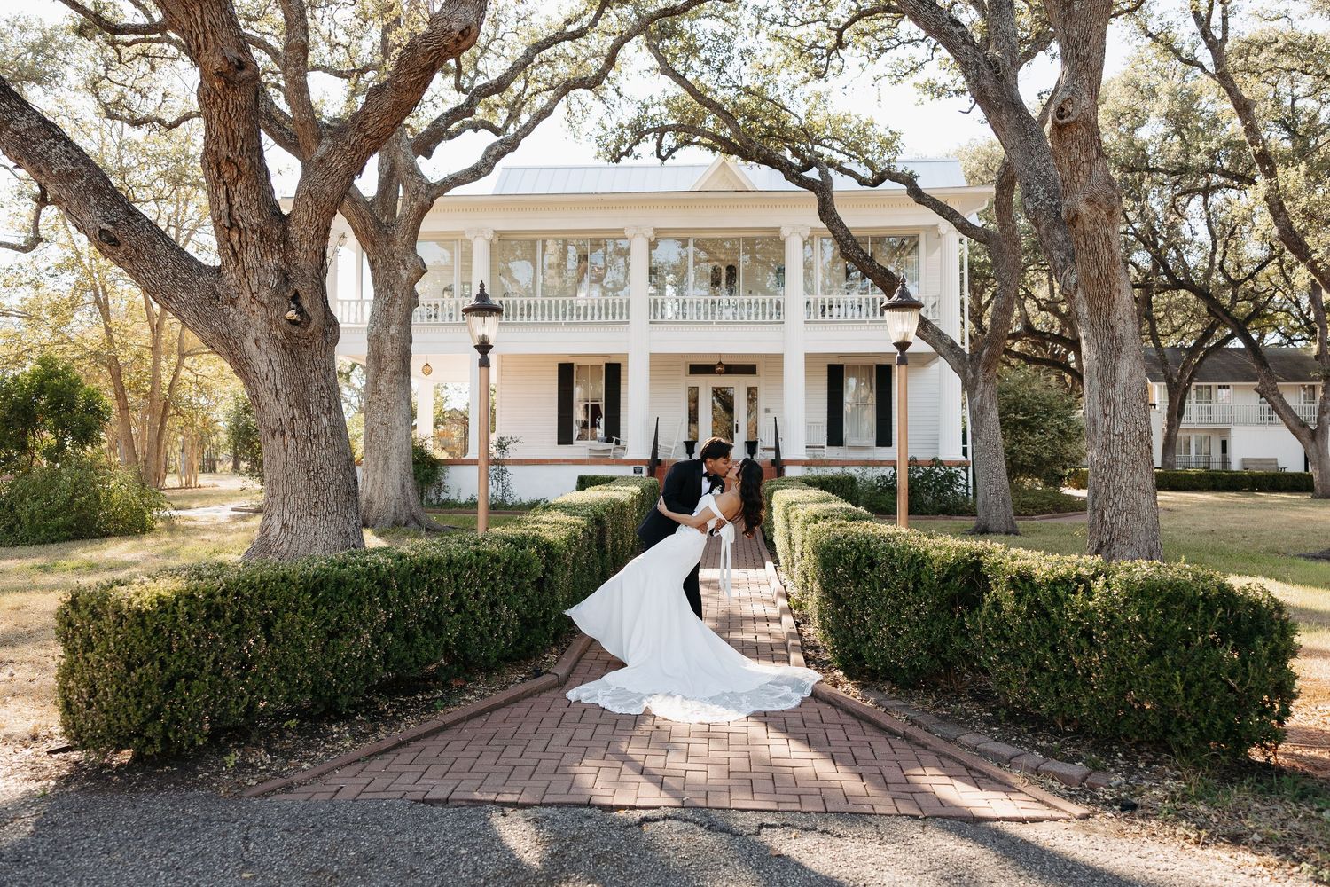 Wedding couple shares emotional first look moment beside piano in sunlit room.