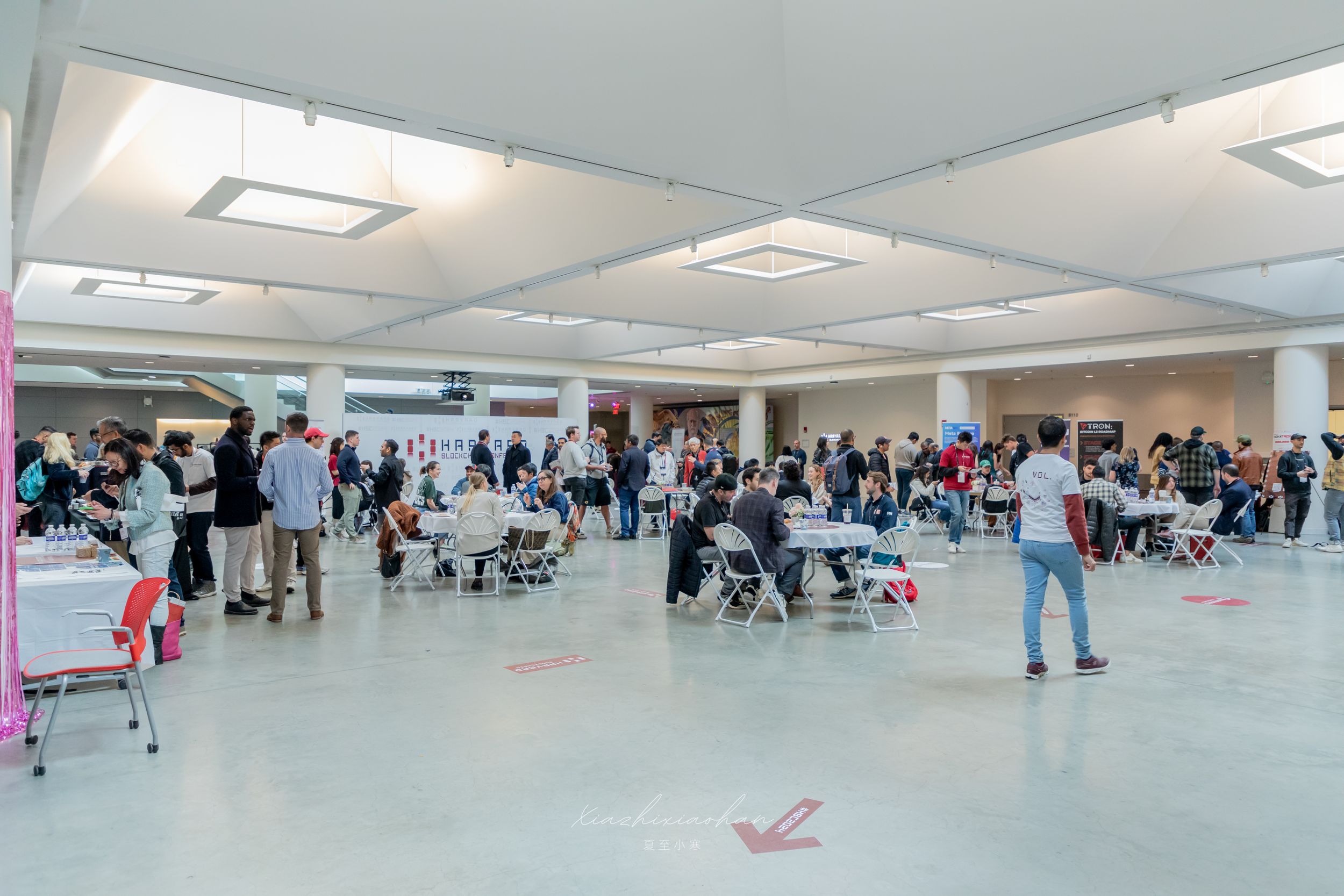 Large conference room filled with attendees during a professional event.