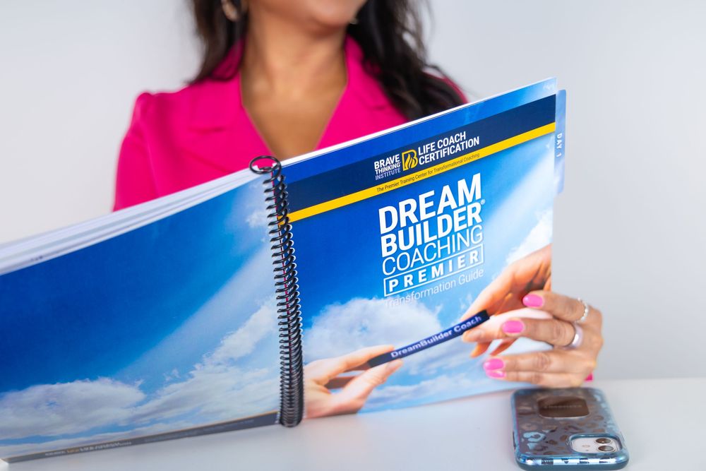 An up close image of a life coach holding a life coaching text book taken at a studio in Hinton