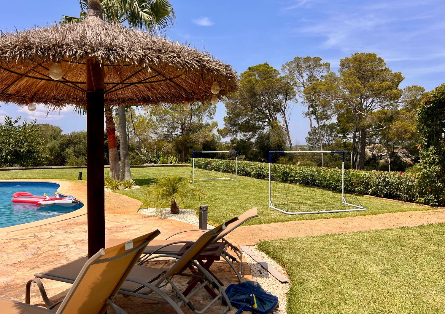 Five panoramic beachfront photos showing ocean views, lounge chairs, and thatched umbrellas at a tropical resort.