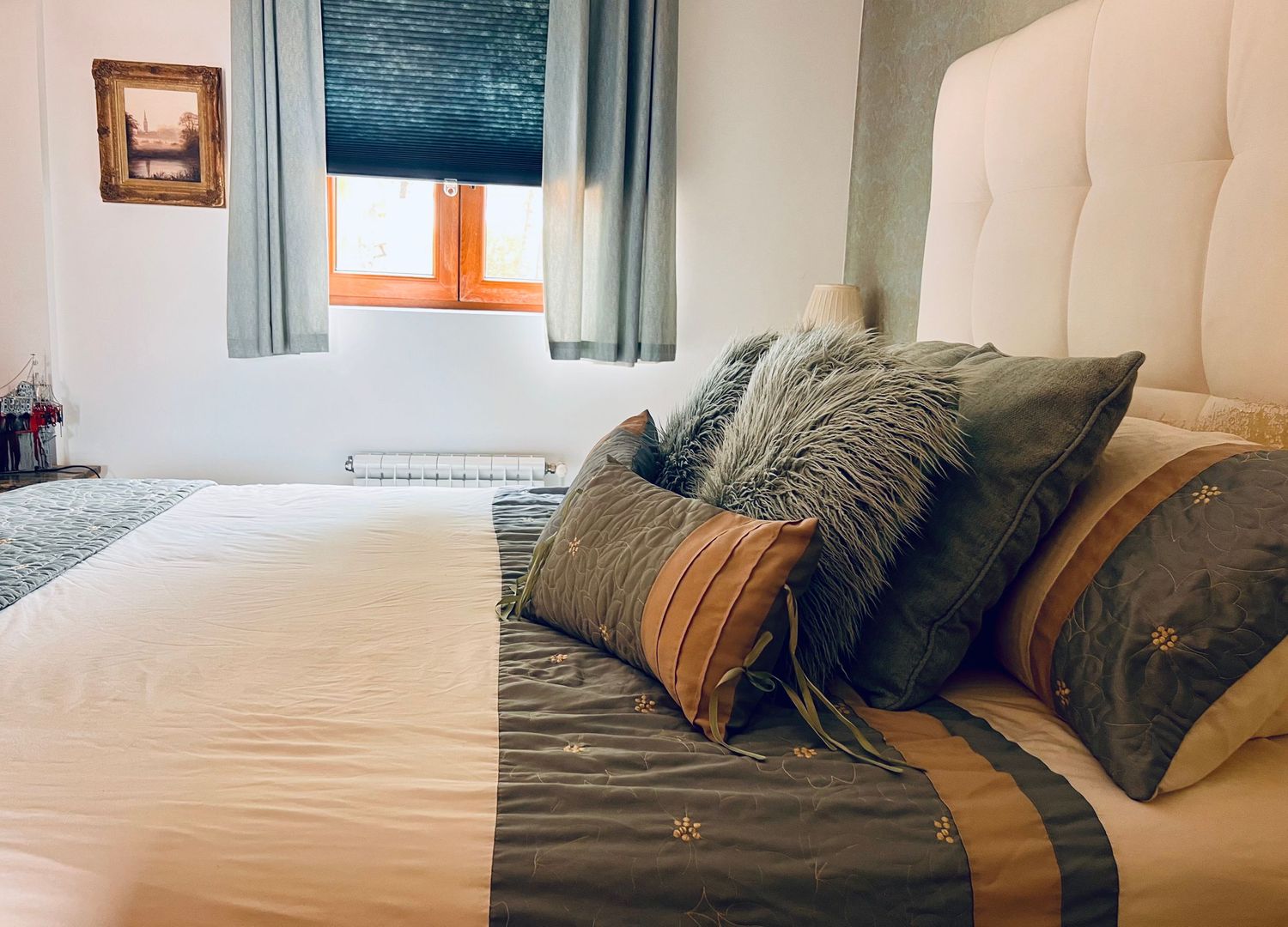 Multiple photos showing different views of a bed with gray pillows and comforter against light-colored walls.