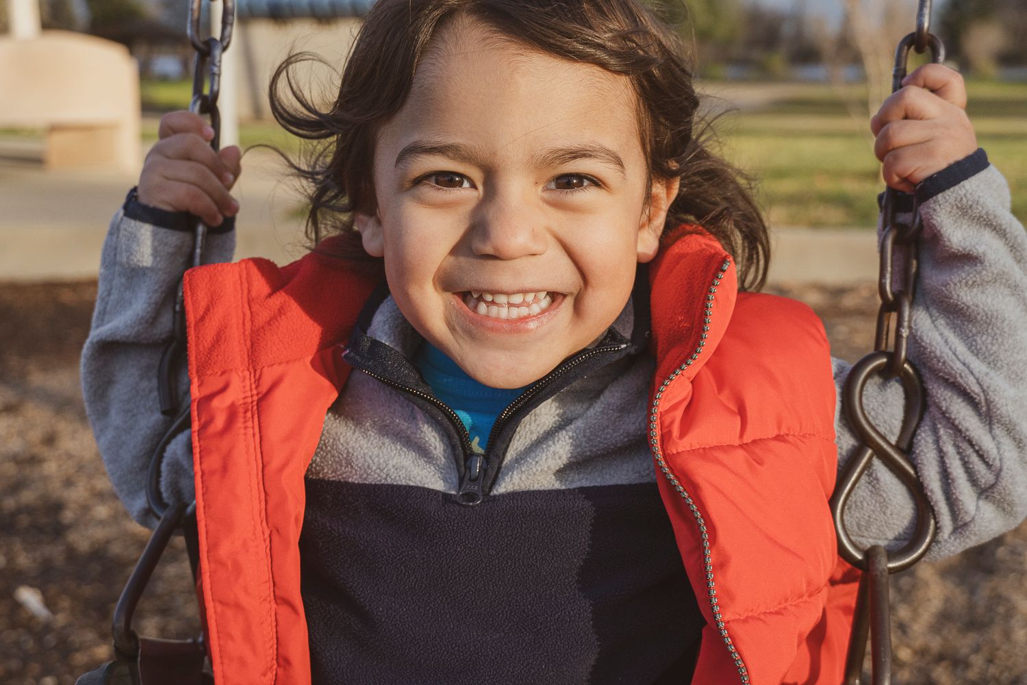 outdoors, child smiling.