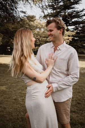 A couple looking at each other smiling.