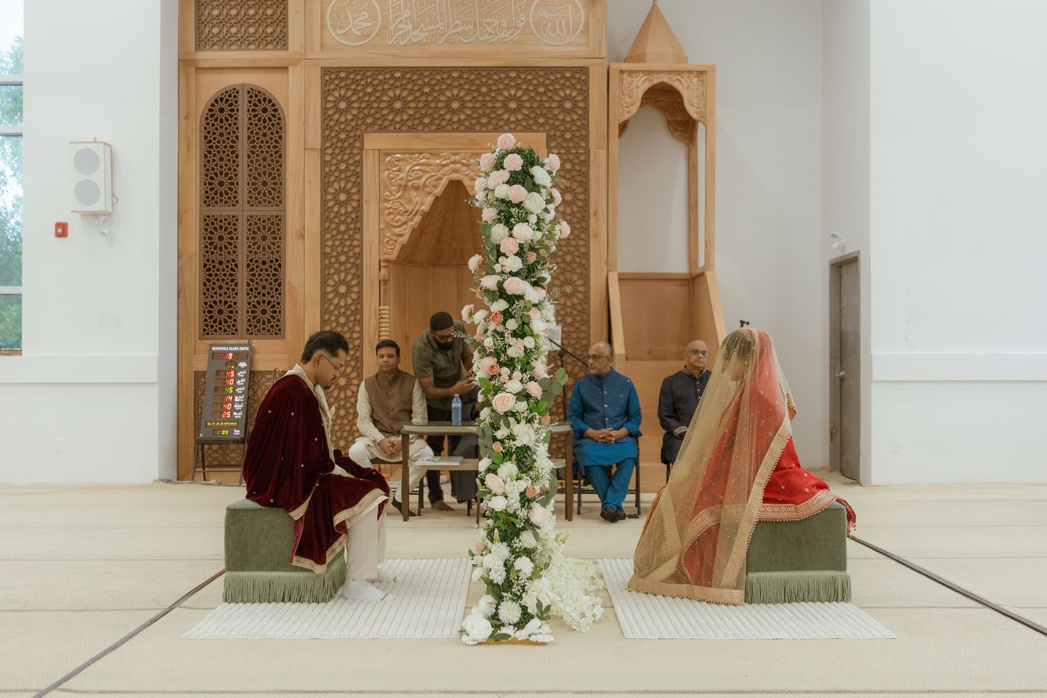 Bride and groom sharing a joyful moment on their wedding day, surrounded by elegant decor and loved ones.