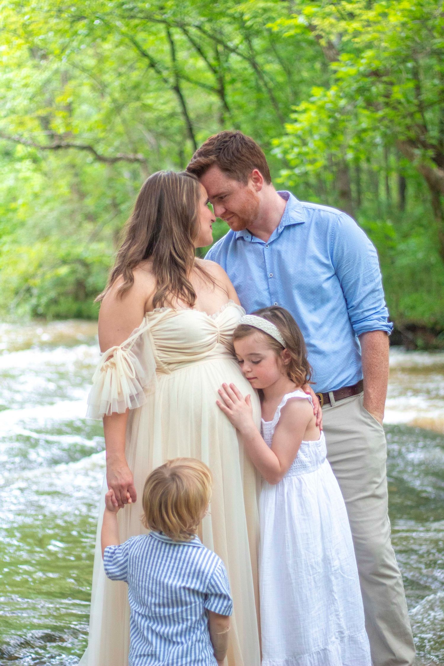 Maternity Session: Mom and Dad looking in each other's eyes as children embrace/look on