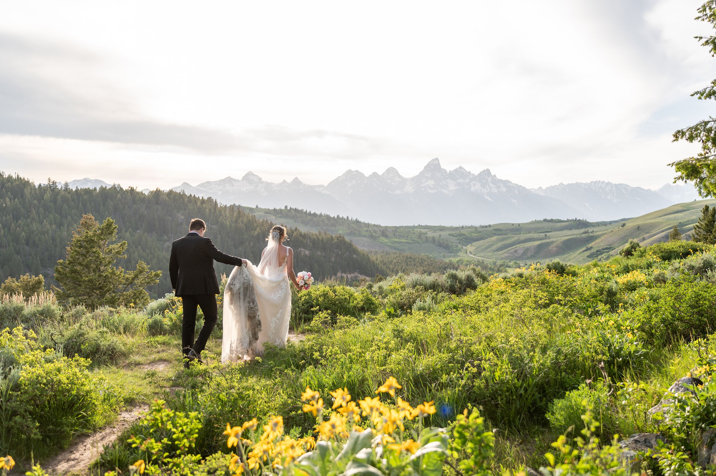 Wedding Tree Wedding. Bride and groom in wild flowers. Grand Teton Wedding. Bride and groom in the Tetons. Jackson Hole Wedding Photographer