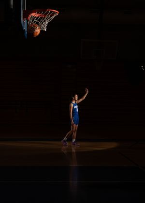 Basketball player shooting ball.