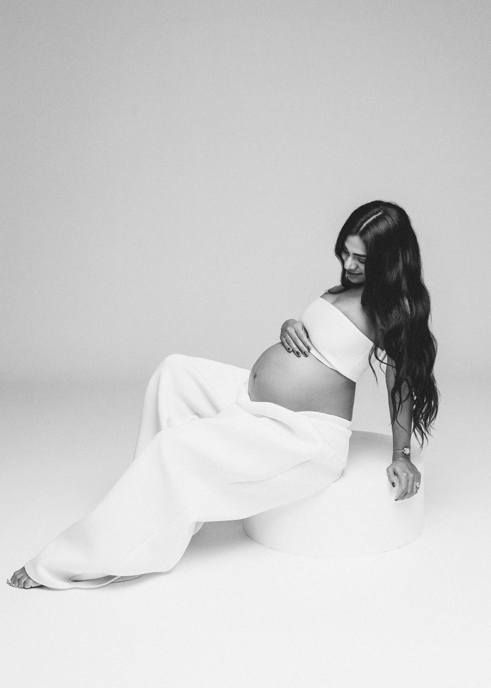 A minimalist black and white photo series showing a figure in flowing white fabric against a light background.