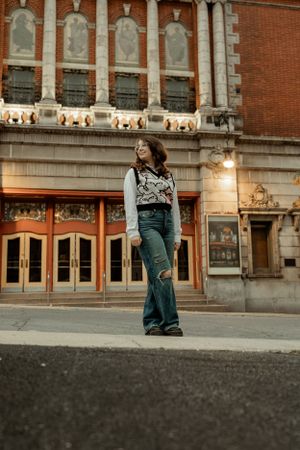 Vintage theatre facade with ornate architecture and decorative lighting at dusk.