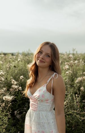 Pretty summer dress photographed in a wildflower meadow during golden hour with soft natural lighting.