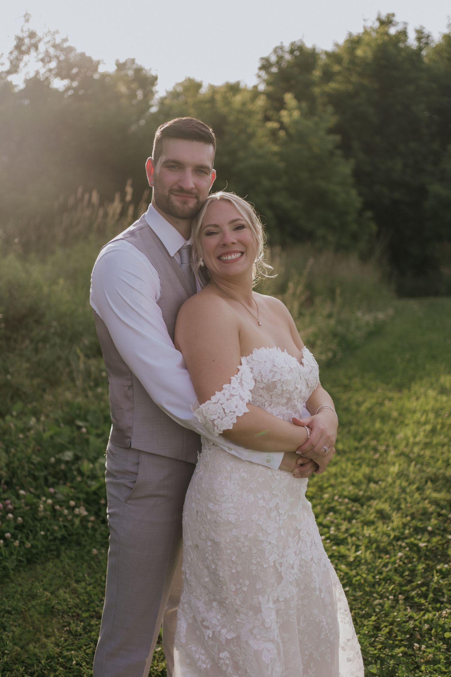 Couple shares playful moment by fountain during wedding photo session.