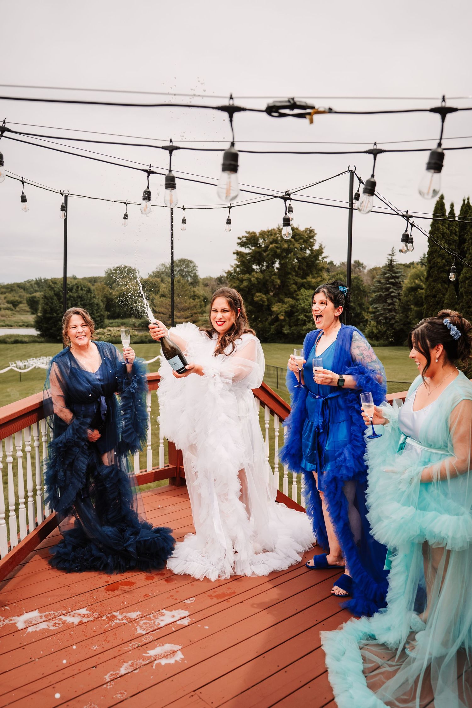 A playful series of dance photos on a wooden deck with people wearing blue and turquoise tulle dresses.