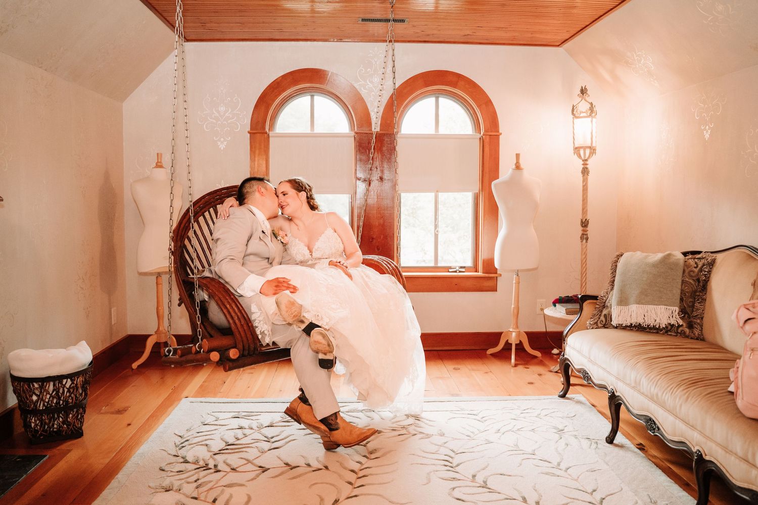 A tranquil scene from a wedding ceremony in a naturally lit white church with wooden pews.