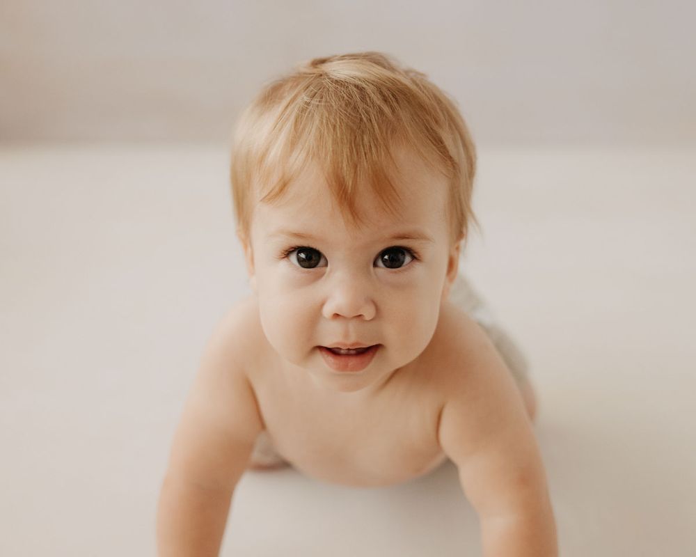 Series of candid baby portraits showing playful expressions against white background.