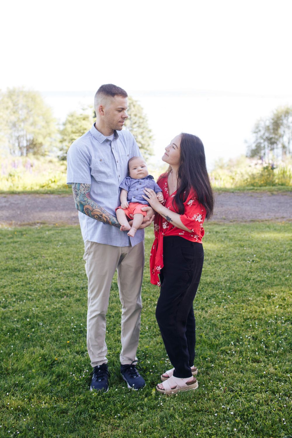Harborview Park family photos in Mukilteo WA: A mother and dad with their newborn baby at a family photo session