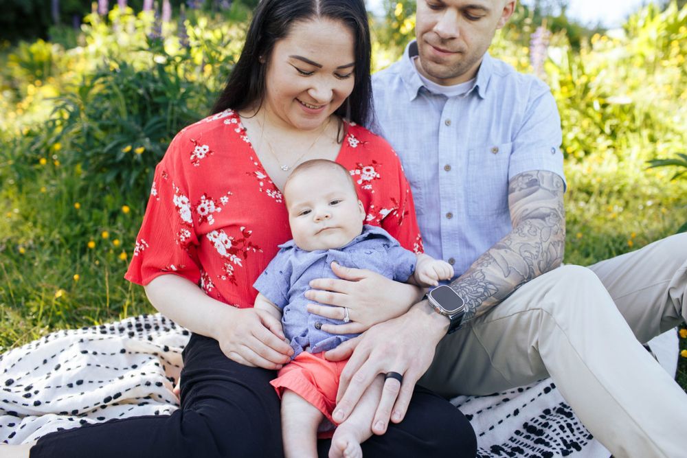 Harborview Park family photos in Mukilteo WA: A mother and dad with their newborn baby at a family photo session