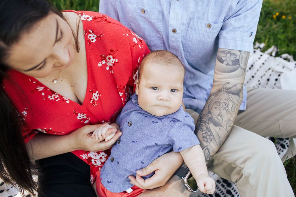 Harborview Park family photos in Mukilteo WA: A mother and dad with their newborn baby at a family photo session