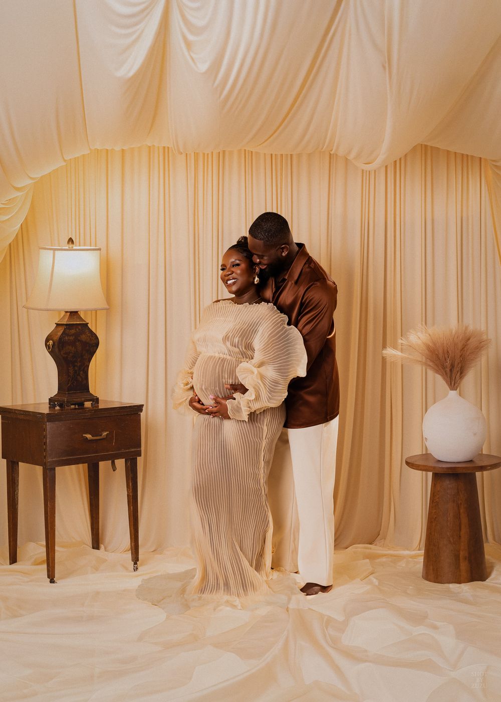 A series of ethereal photographs showing draped white fabric and brown furniture against cream-colored walls in an artistic setup.