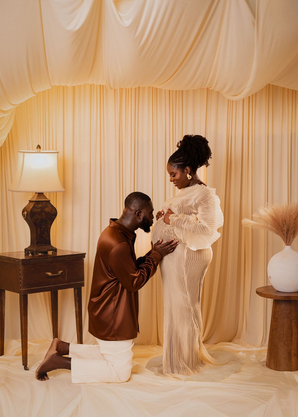 A sequence of photos showing a figure in brown interacting with white fabric drapes against a cream-colored backdrop.