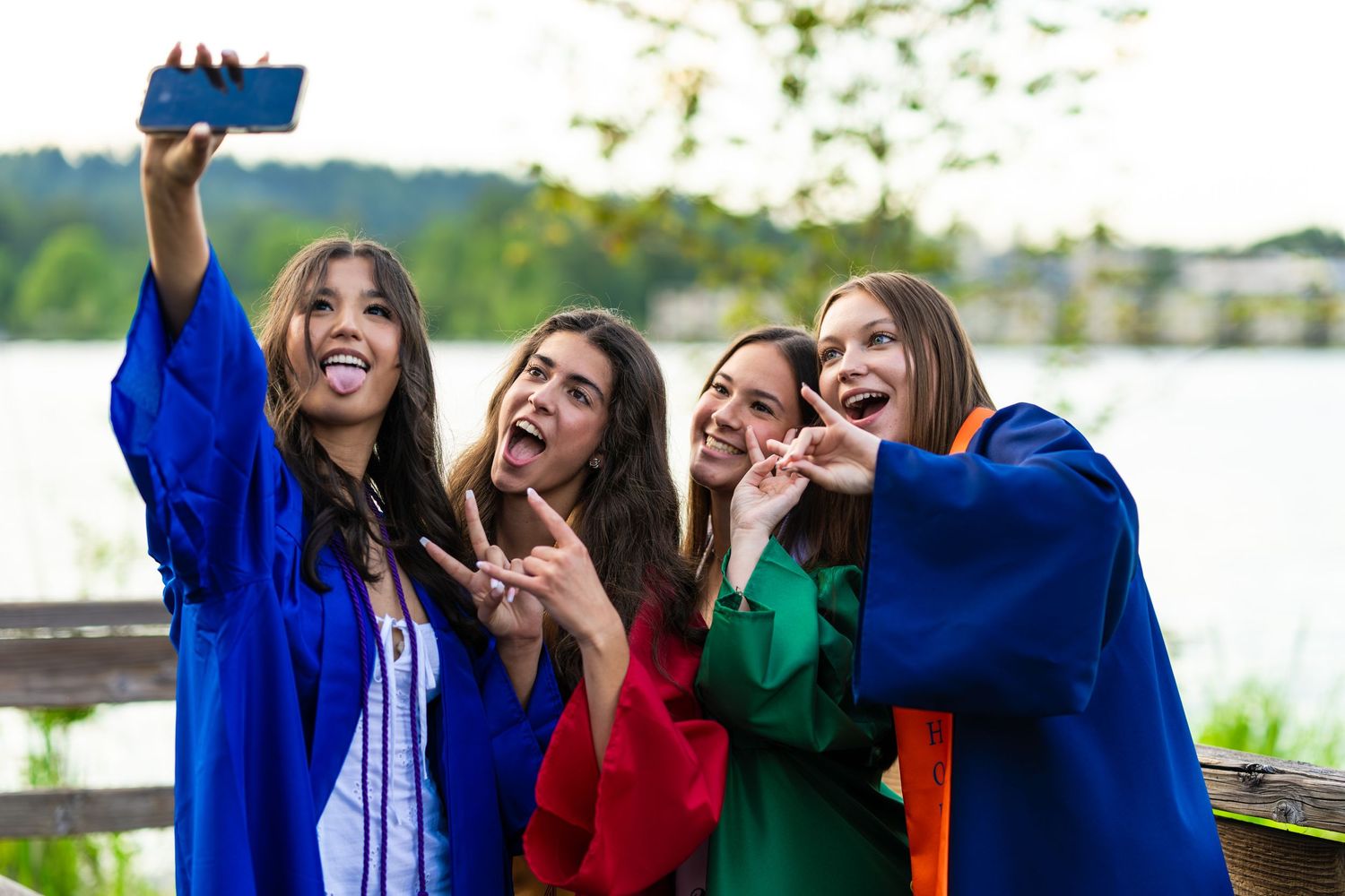 A group of female soccer players from various high schools in the metro Seattle area are posing for a graduation photo.