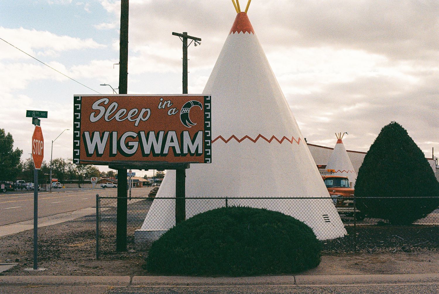 Row of teepee-style motels and Wigwam signs along a vintage roadside attraction.