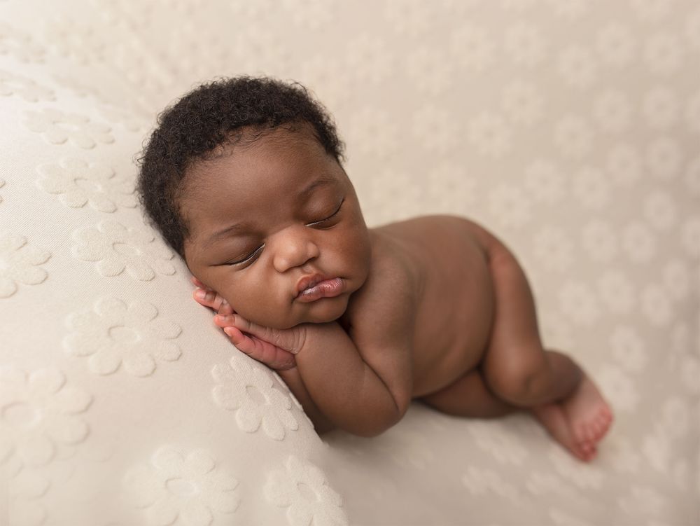 Gentle newborn photography portraits showing peaceful sleeping positions on soft cream-colored textured backgrounds.