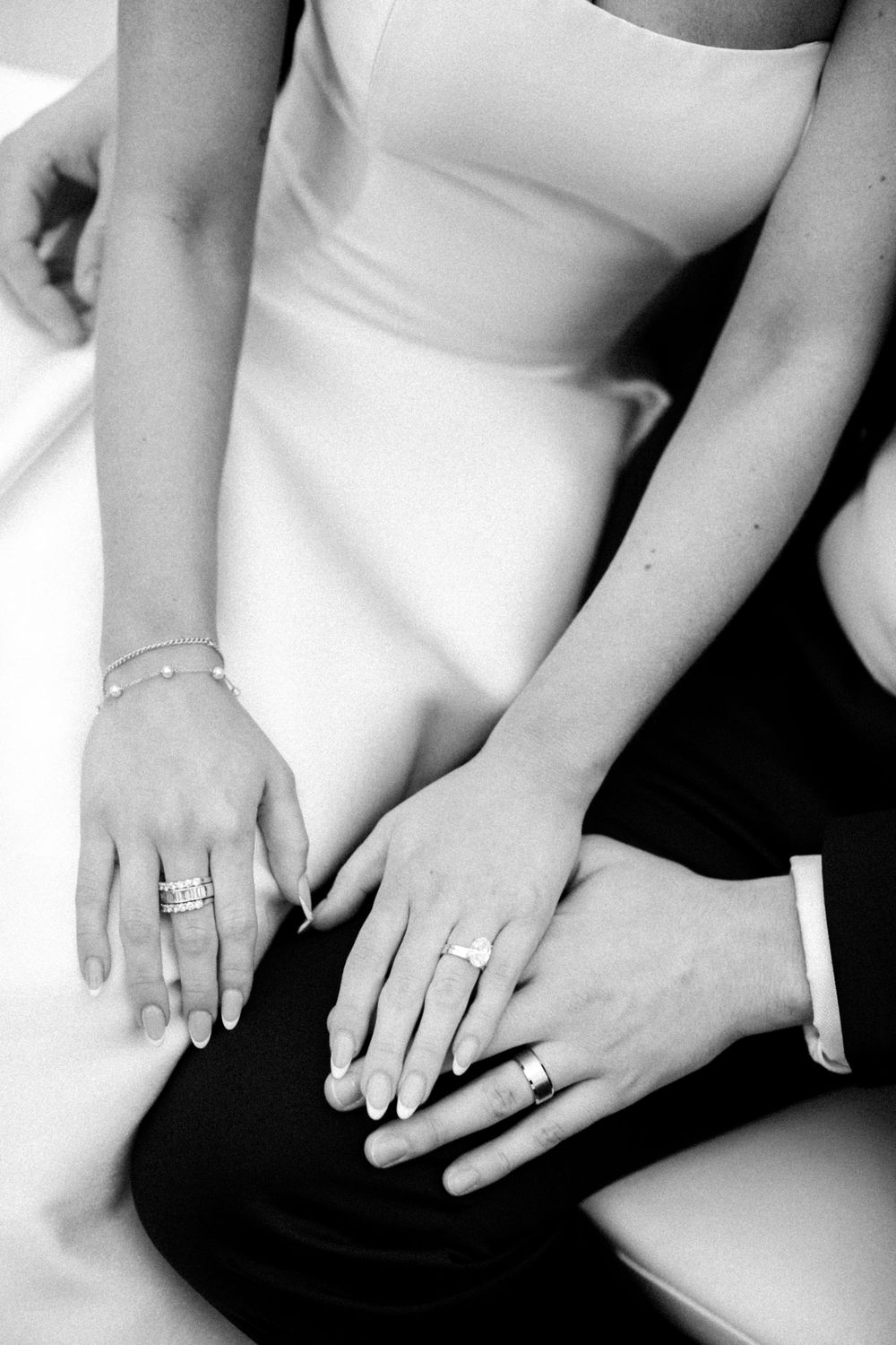 Close-up of bride and groom's hands wearing wedding rings after the ceremony.