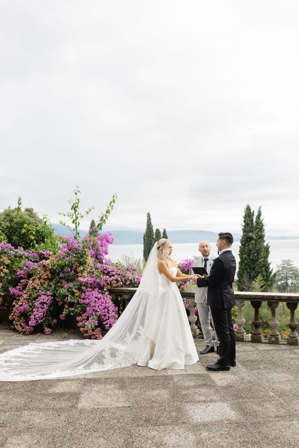 Couple eloping at sunset on Isola del Garda with lake views