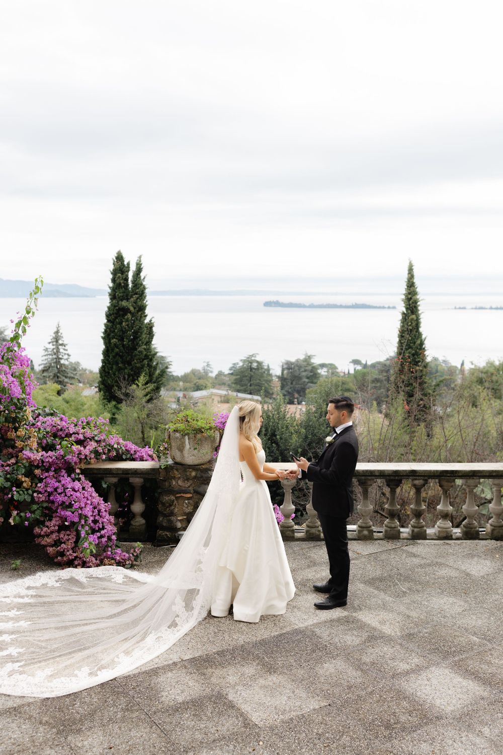 Couple eloping at sunset on Isola del Garda with lake views