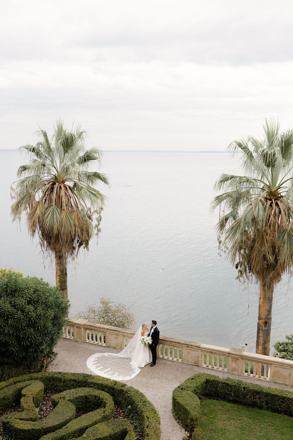 Couple eloping at sunset on Isola del Garda with lake views