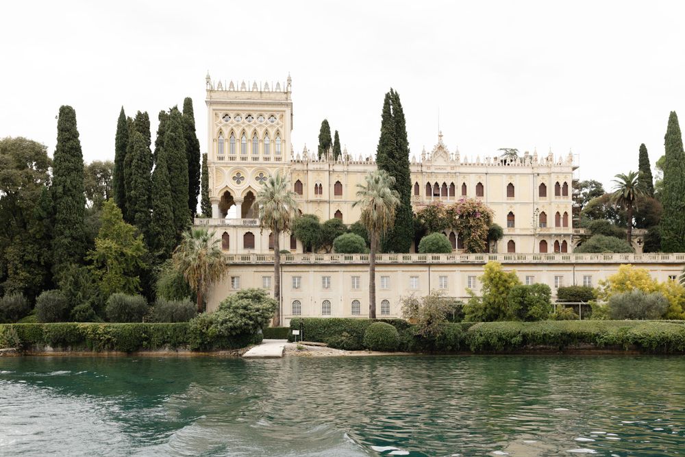 Couple eloping at sunset on Isola del Garda with lake views