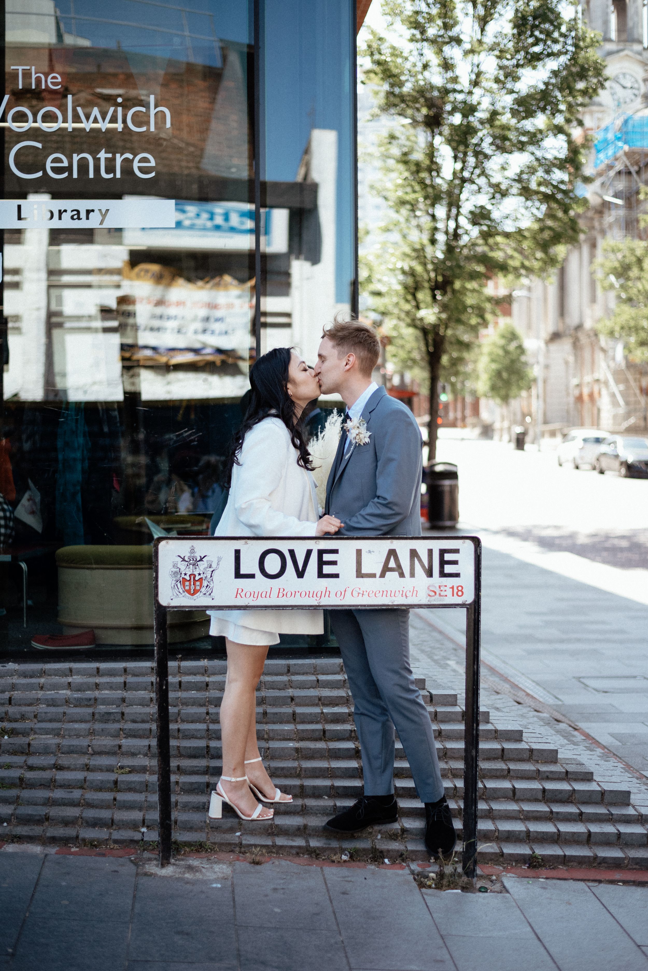 Newlyweds sharing romantic moment on bench at Love Lane.