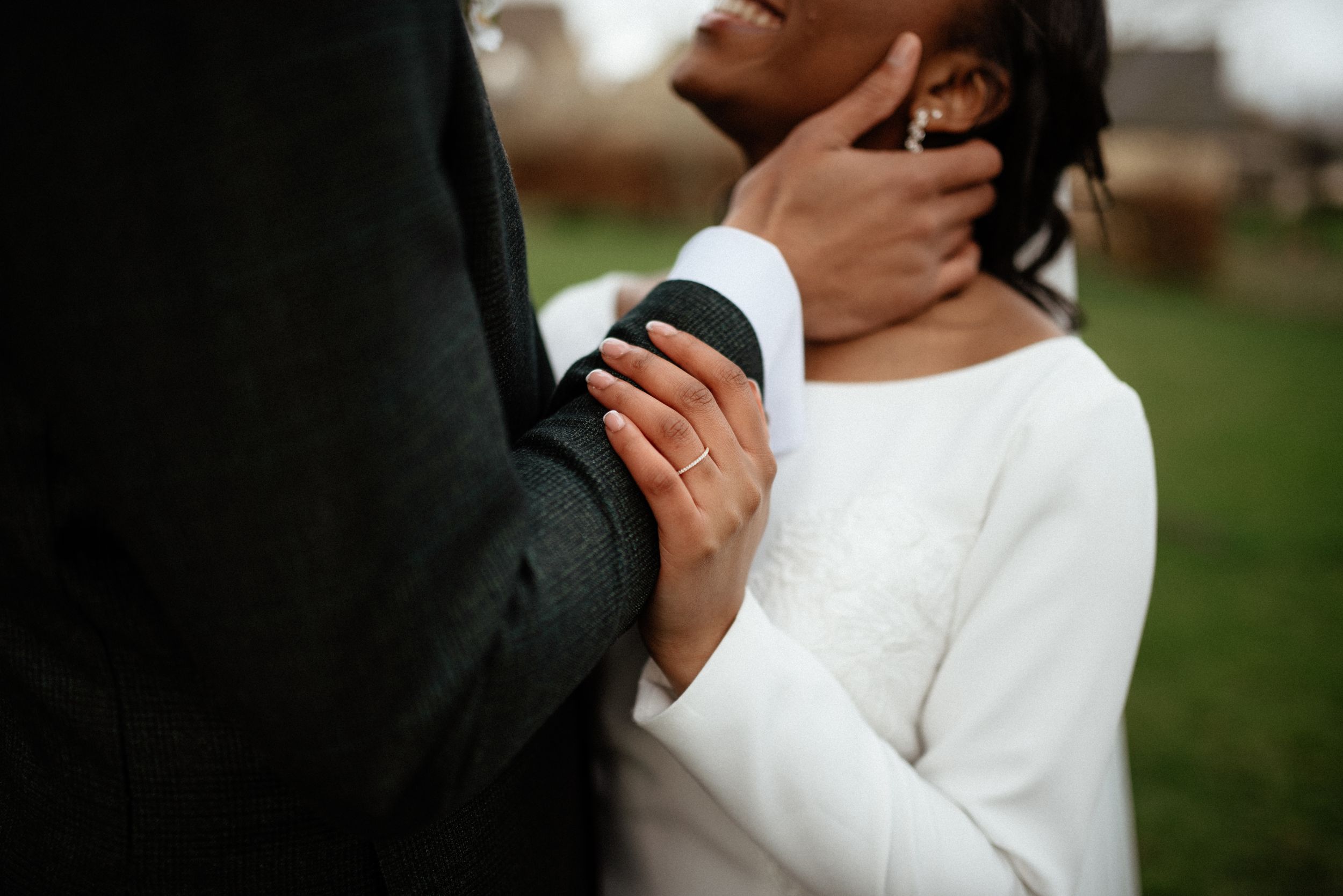 Elegant couple shares intimate moment in formal wedding attire.