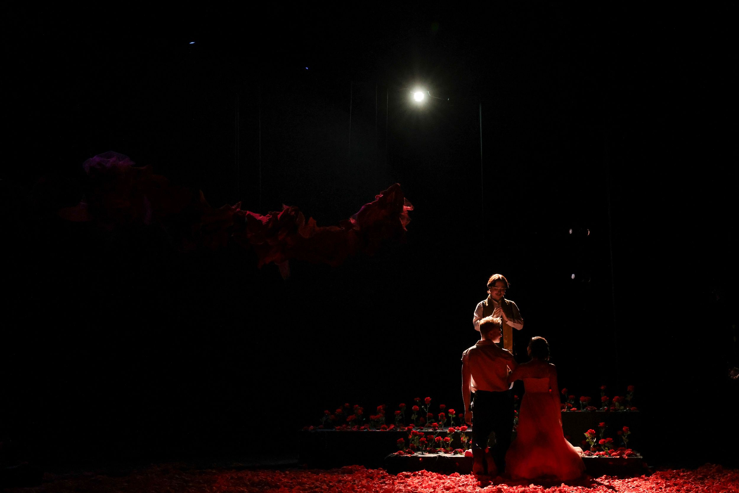 A romantic scene dramatically lit during a production of Romeo & Juliet by William Shakespeare. Theatre photography.
