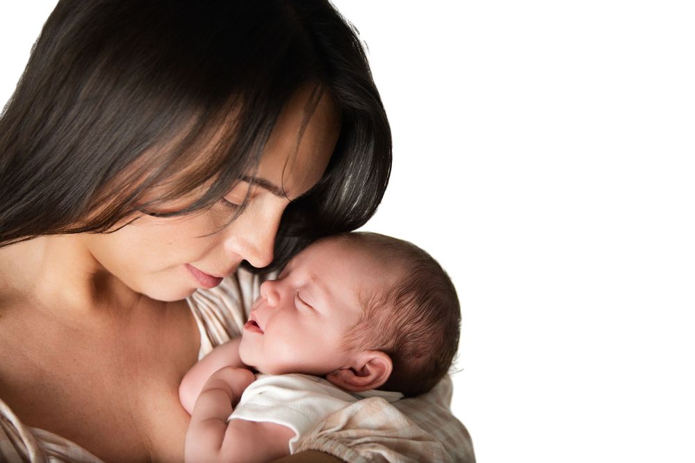 mother a son photo of mother and newborn baby boy cuddling and almost touching noses
