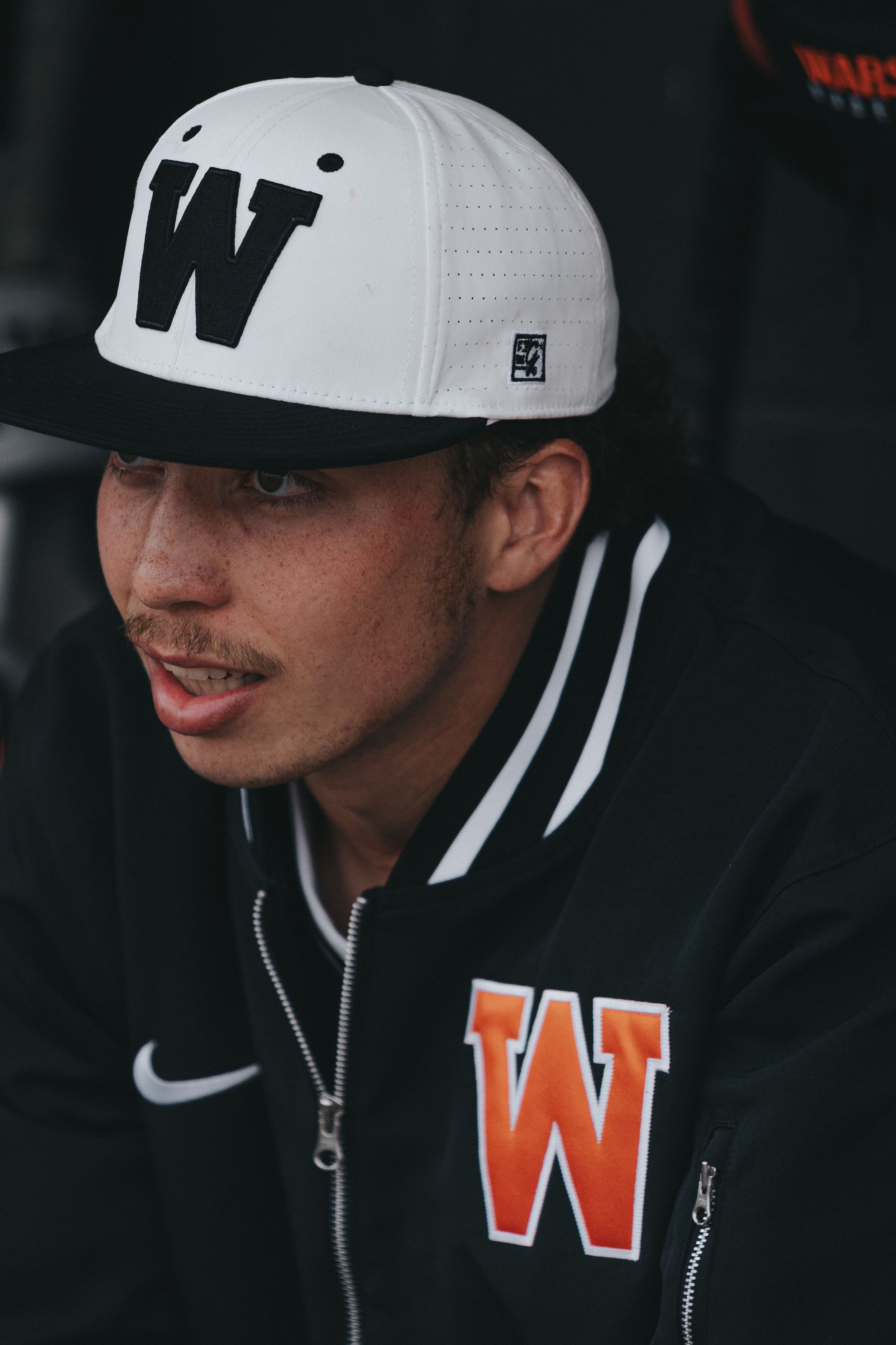 Dynamic Sports Photography shot of a baseball pitcher in uniform sitting in the dugout - Warsaw, Indiana