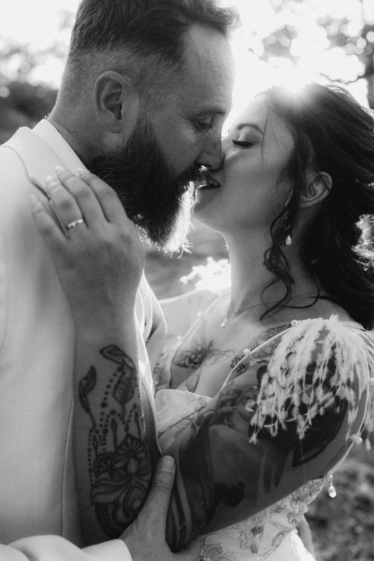 A tender autumn embrace captured during a wedding photoshoot with fall foliage.