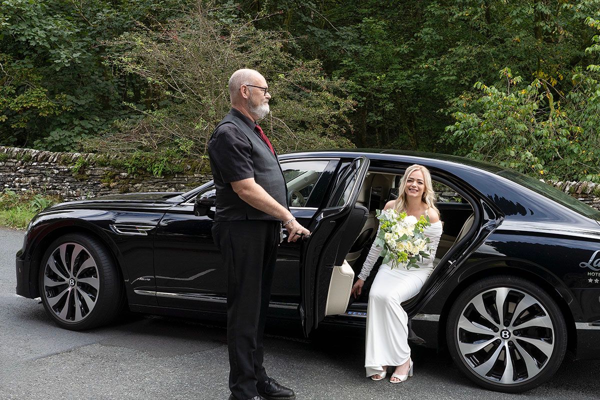 Anna elegantly exits her wedding car to attend her elopement wedding at Troutbeck Windermere