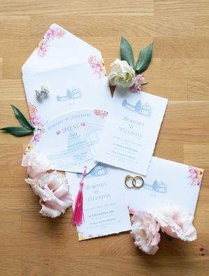 Wedding invitation suite for Dorothy and Valentine with floral envelope liner, pink tassels, and gold rings.