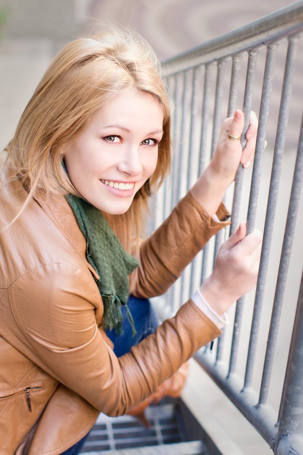 Senior girl pictures in Howell, MI; girl on metal stairs downtown, by South Lyon, Michigan photographer