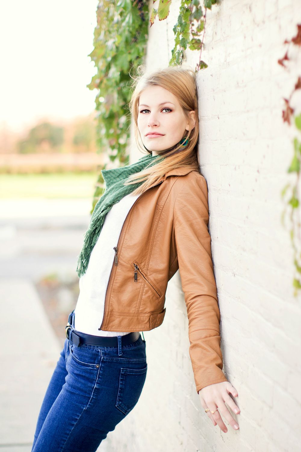 Senior girl photos in Howell, MI; girl standing in against brick wall downtown, by South Lyon, Michigan photographer