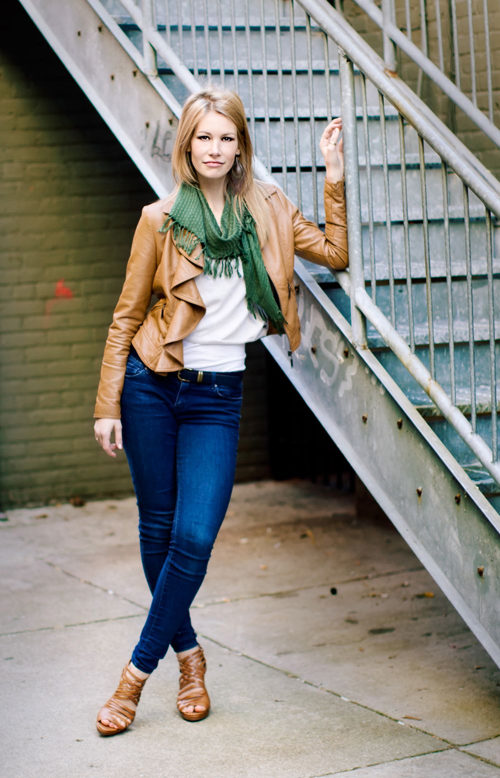 High school senior girl portrait in Howell, MI; photo of girl leaning against metal stairs downtown, by South Lyon, Michigan photographer