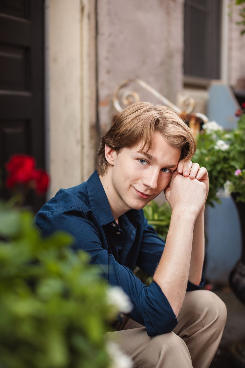 Senior boy picture in The Alley District, Howell, MI; boy sitting on steps downtown, by Brighton, Michigan photographer