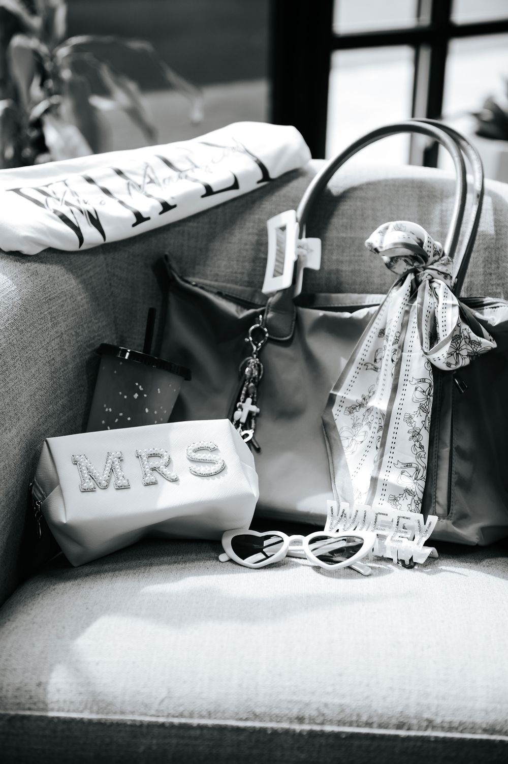 Wedding day accessories including MRS pouch, wifey sunglasses, and tote bag.
