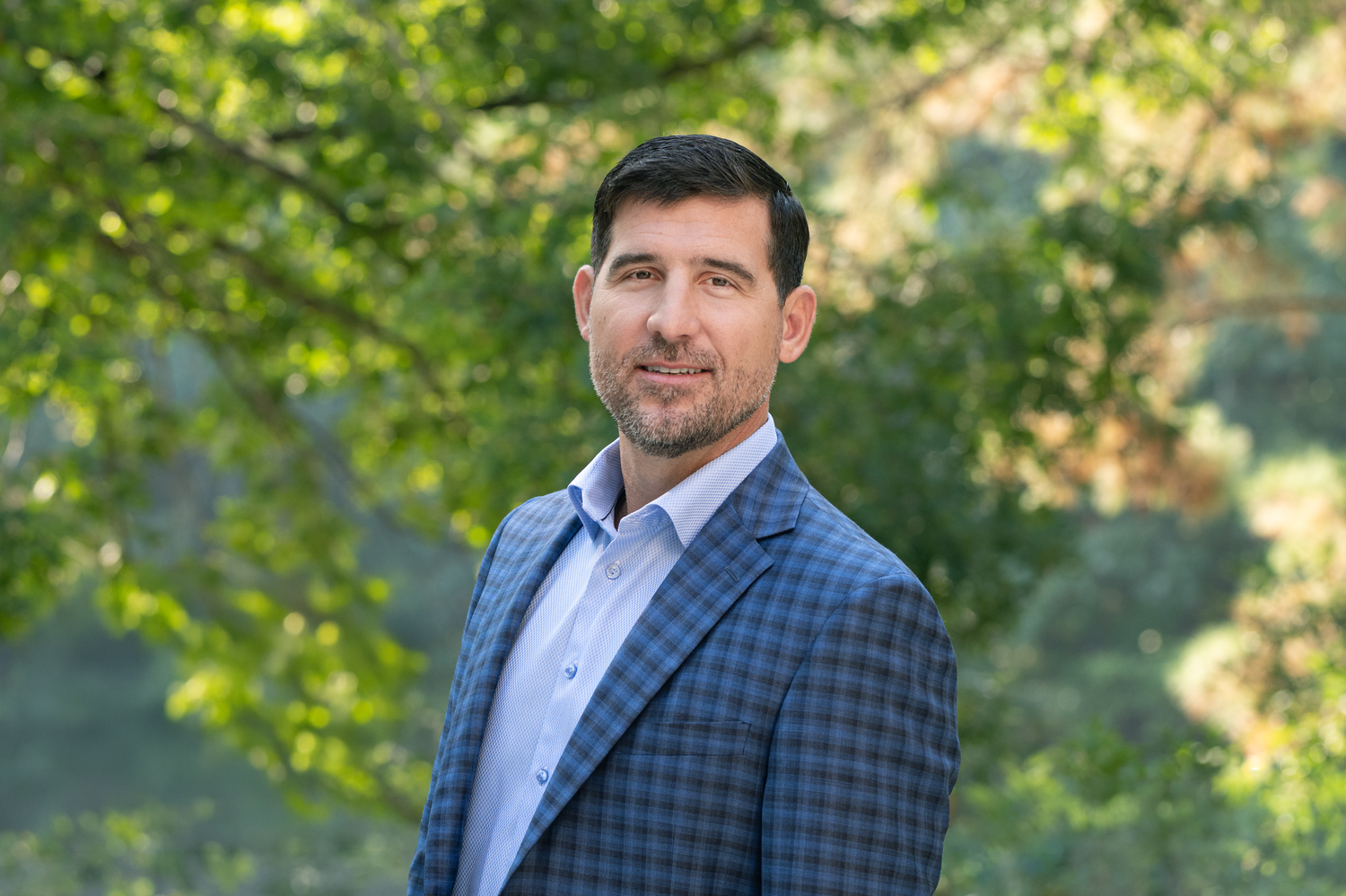 Outdoor professional headshot of a businessman in a blue blazer in Fayetteville, NC
