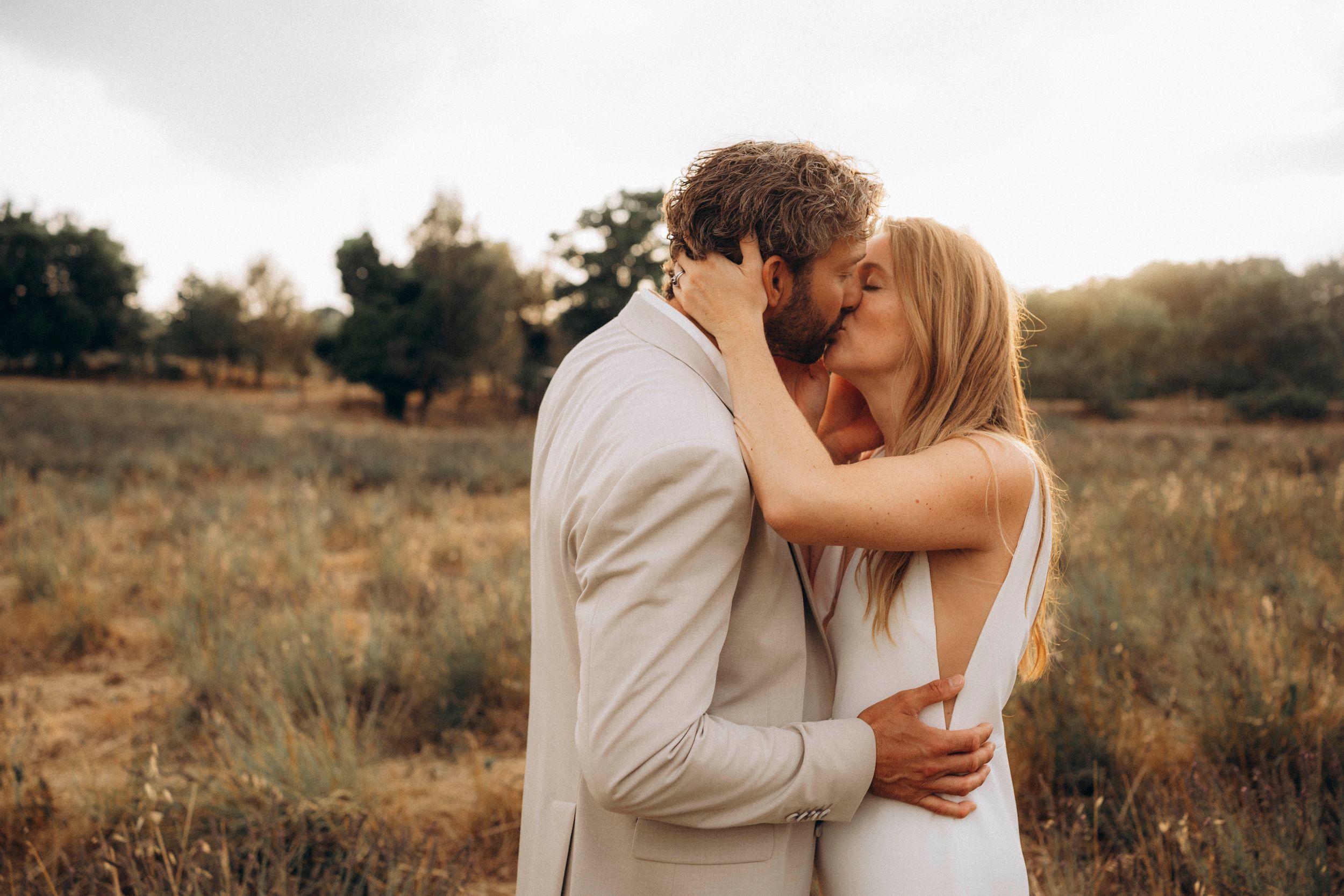 A romantic dance silhouette under stone archways with warm lighting.