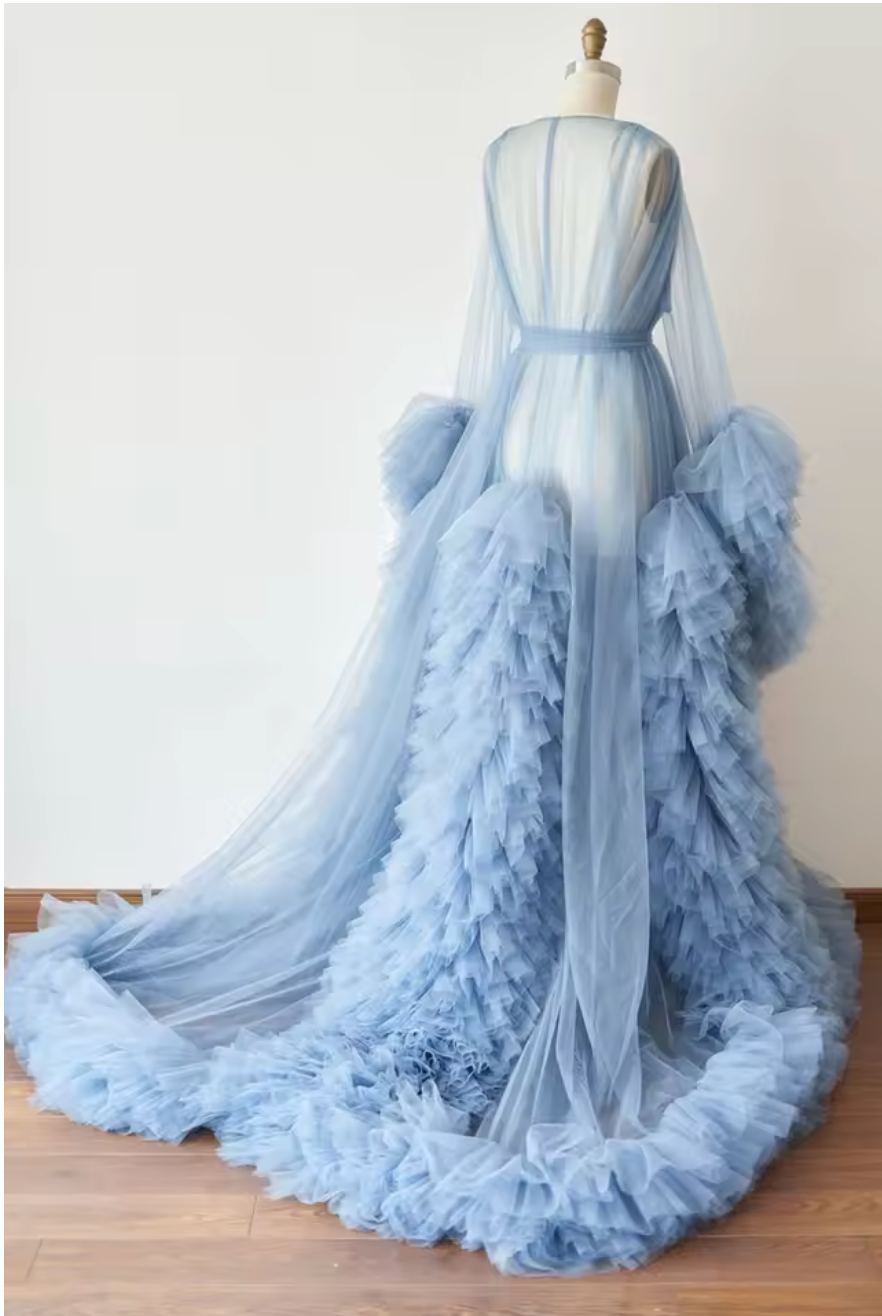 Elegant dusty blue tulle robe with ruffled trim and long train, displayed on a dress form.