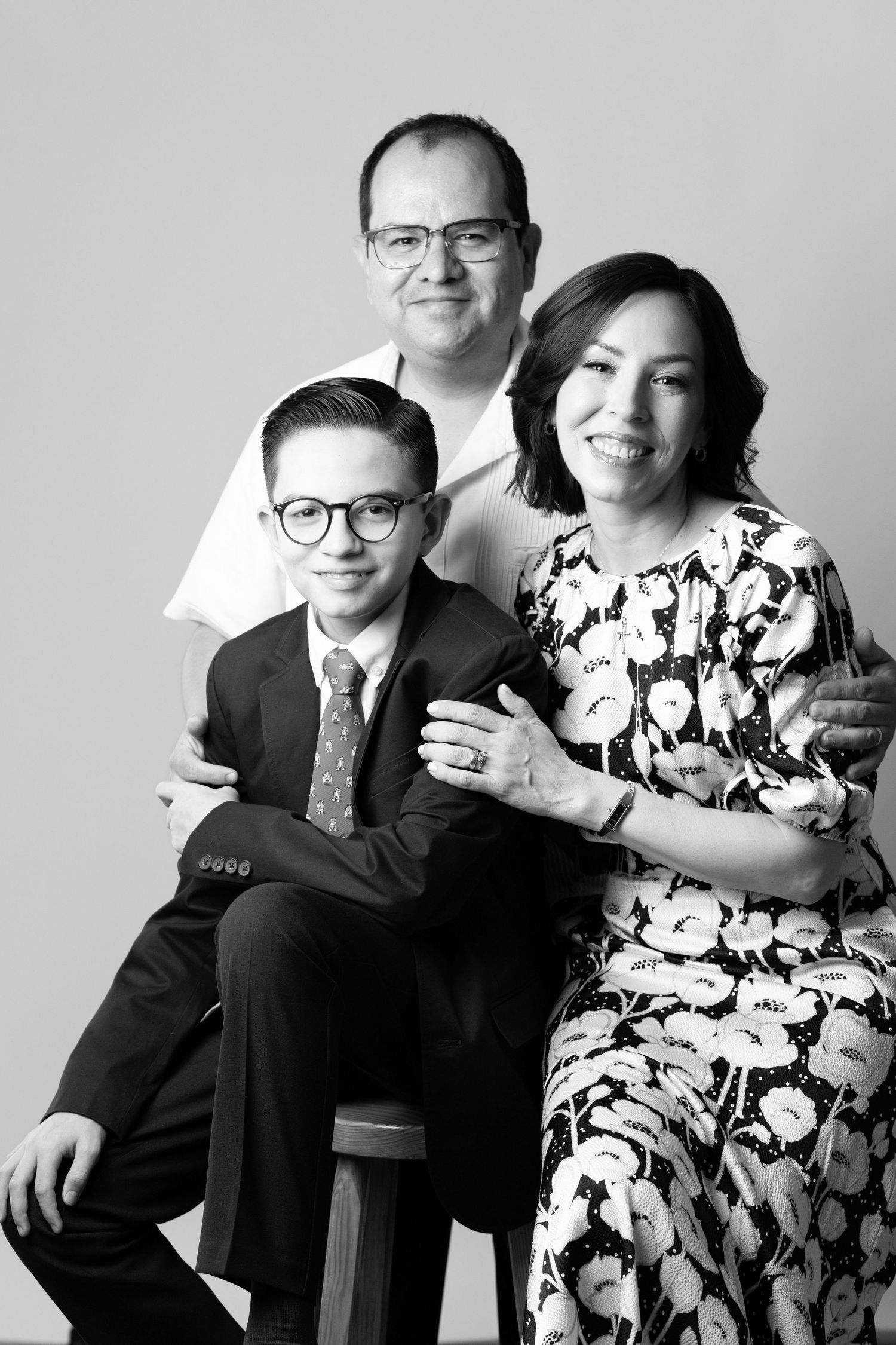 Studio family portrait in black and white with formal attire.