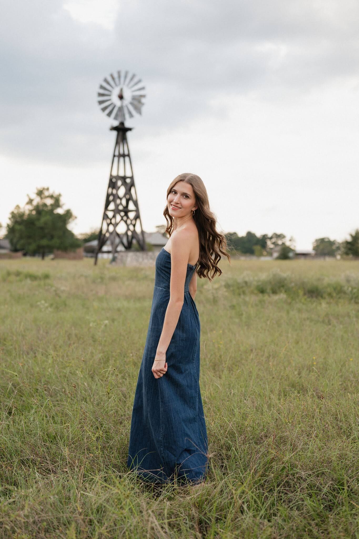College Park High School senior girl posing in a grassy field in Tomball Texas