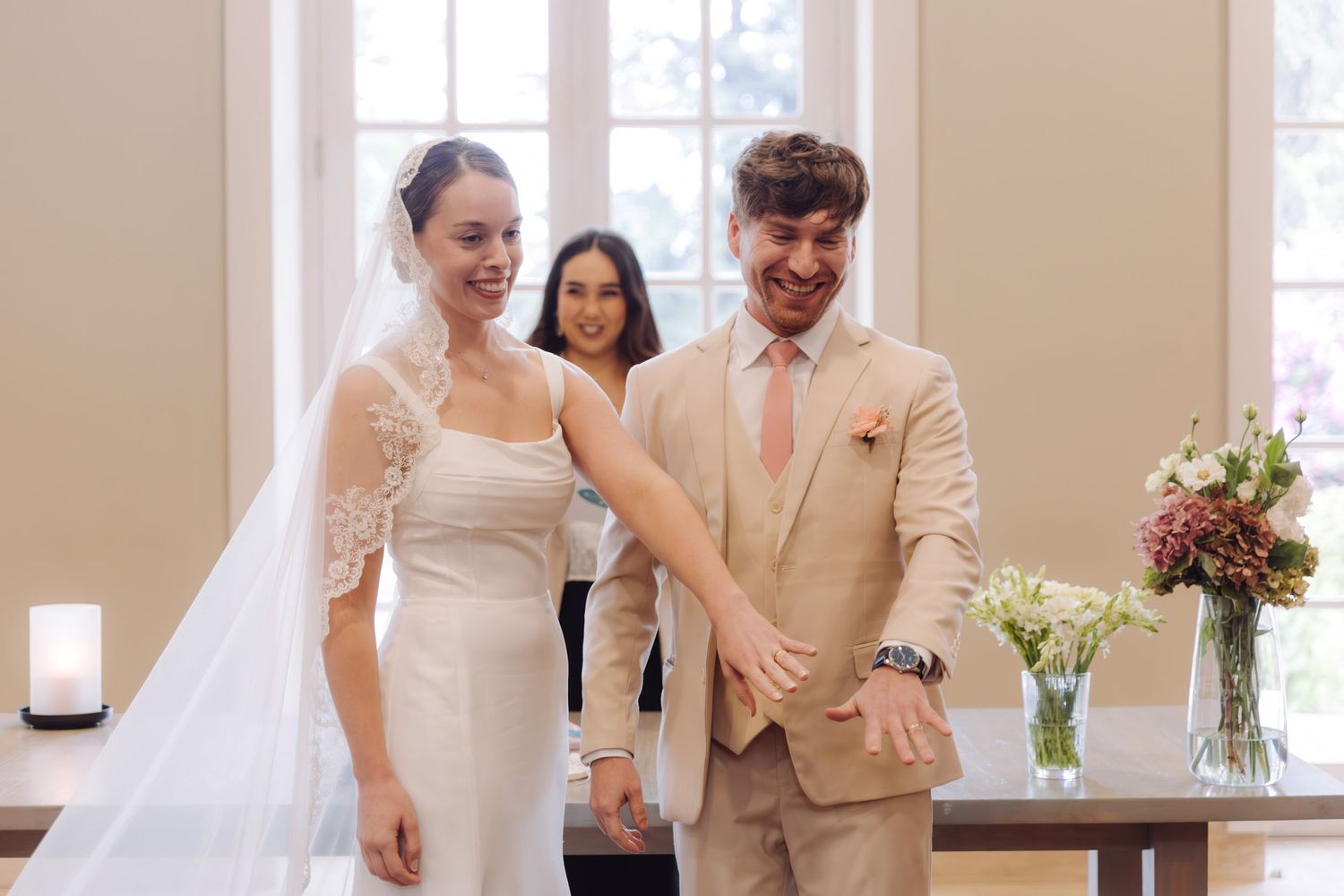 Bride and groom share joyful moment after exchanging vows at their wedding ceremony.